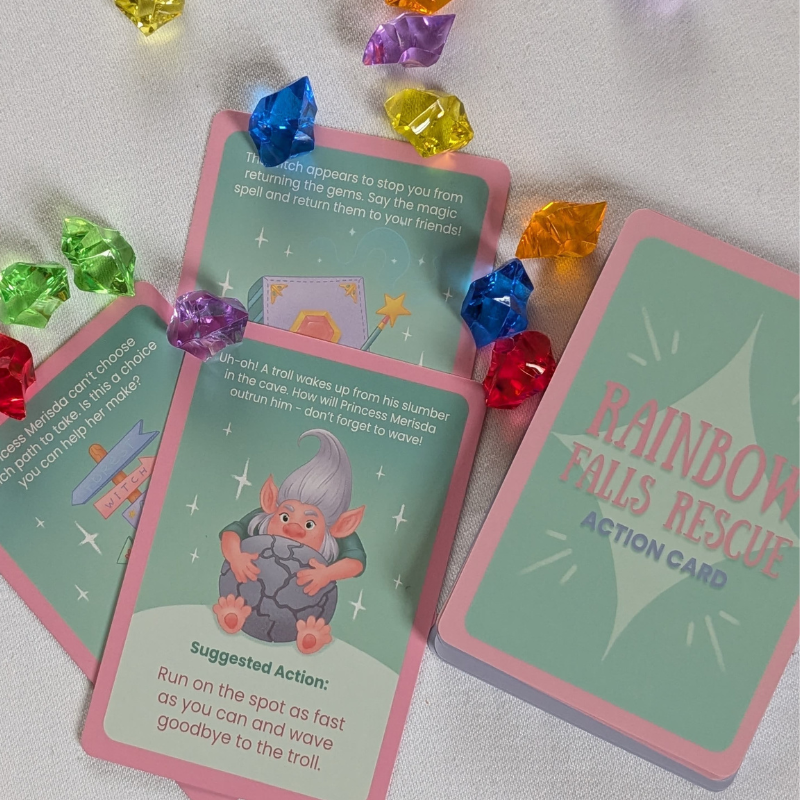 Cards featuring illustrations of fantasy situations with rainbow coloured gems scattered across the page.