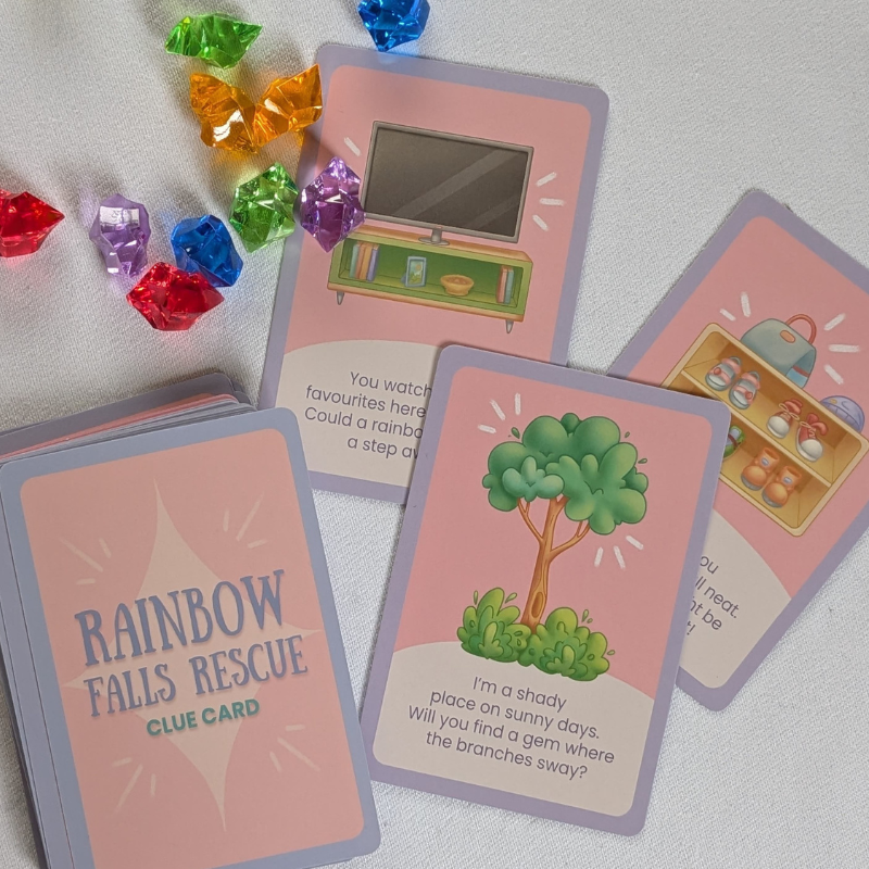 Cards featuring illustrations of locations normally found indoor and outdoors and the back cover of the card with rainbow coloured gems scattered across the page.
